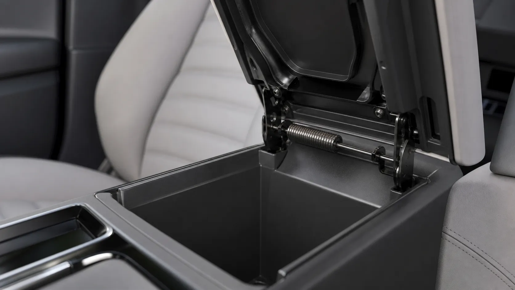 Constant torque spring in an automotive interior storage compartment lid